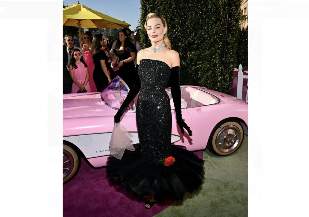 Robbie posed for pictures in front of a pink Corvette